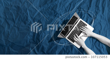 Person using a laptop computer with crumpled paper texture 107115053