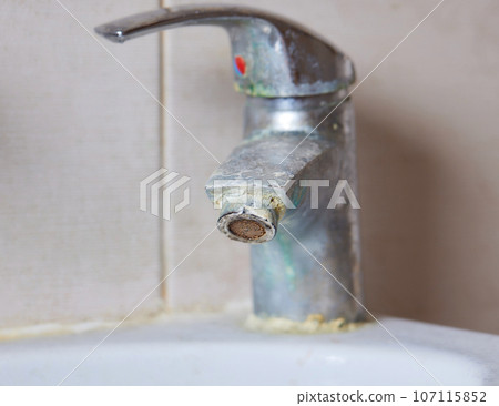 Rusted faucet, macro shot of rusted faucet. Water scarcity and water consumption concept idea. 107115852