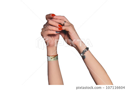 Gesture of the girl's hands and fingers hands raised up while dancing with a red manicure and jewelry on a white isolated background 107116604
