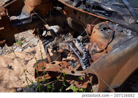 A cropped front view of a burned and abandoned rusty van and broken headlight. A cropped front view of a burned and abandoned rusty van and broken headlight. 107116882