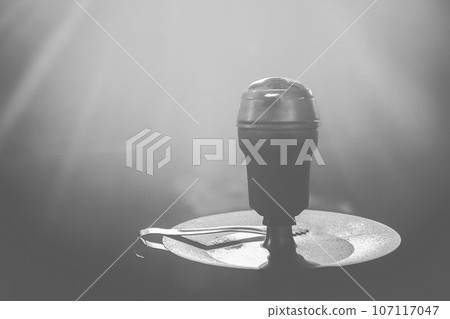 Hookah head bowl smoking object in grey dark light close-up Hookah head bowl smoking object in grey dark light close-up 107117047