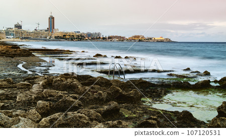 View to St. Julian's real estate from Sliema coast. Storm at sea, evening time. 107120531