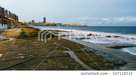 View to St. Julian's real estate from Sliema coast. Storm at sea, evening time. 107120532