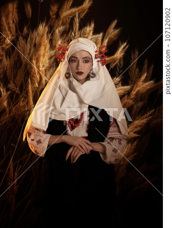 Woman as motanka . Traditional costume. Symbolism, ancient magic, force of nature, cosplay Woman as motanka . Traditional costume. Symbolism, ancient magic, force of nature, cosplay 107120902