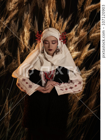 Woman as motanka . Traditional costume. Symbolism, ancient magic, force of nature, cosplay Woman as motanka . Traditional costume. Symbolism, ancient magic, force of nature, cosplay 107120903