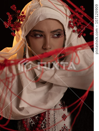 Woman as motanka . Traditional costume. Symbolism, ancient magic, force of nature, cosplay 107120909