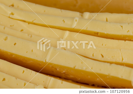 semi- hard cheese with holes cut into chunks semi- hard cheese with holes cut into chunks 107120956