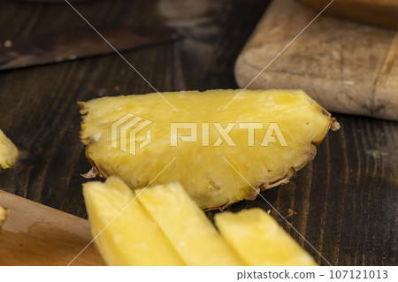 ripe yellow pineapple cut into pieces 107121013