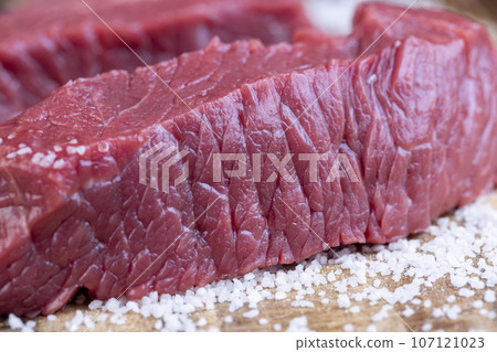sliced piece of fresh raw beef during salting sliced piece of fresh raw beef during salting 107121023