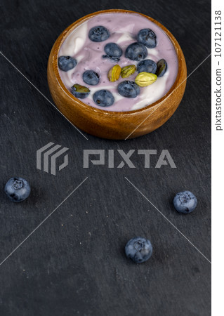 fresh purple and white yogurt with blueberries and blueberry berry flavor 107121138