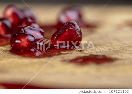 peeled red ripe pomegranate with red sweet grains peeled red ripe pomegranate with red sweet grains 107121192