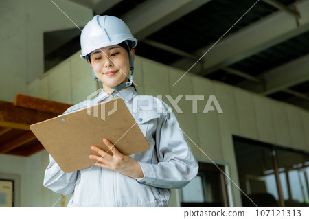 Women in work clothes, helmet Women in work clothes, helmet 107121313