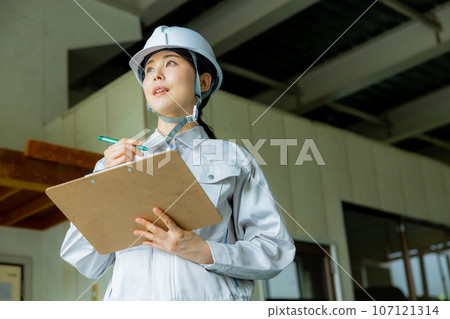 Women in work clothes, helmet Women in work clothes, helmet 107121314