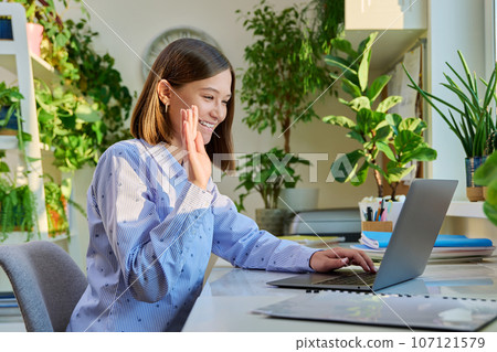 Female student having video lesson conference on computer at home 107121579