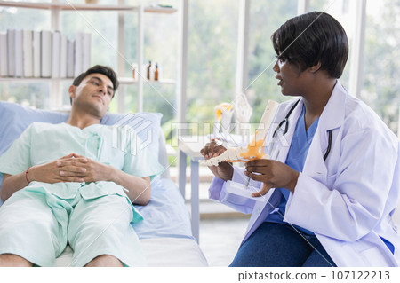 Patient sport male meeting physiotherapist doctor for muscle joint pain physical therapist recovery in hospital clinic Patient sport male meeting physiotherapist doctor for muscle joint pain physical therapist recovery in hospital clinic 107122213