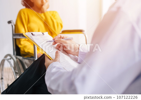 Psychiatrist doctor collect data talk with patient on wheelchair for mental care health problems check followup in hospital clinic Psychiatrist doctor collect data talk with patient on wheelchair for mental care health problems check followup in hospital clinic 107122226