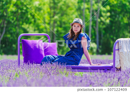 A Beautiful Girl amidst Lavender Fields. A Dreamy Summer Photo Session in the Lavender Field 107122409