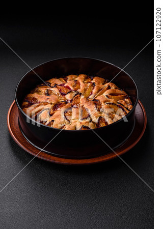 Delicious sweet aromatic homemade pie with ripe plums 107122920