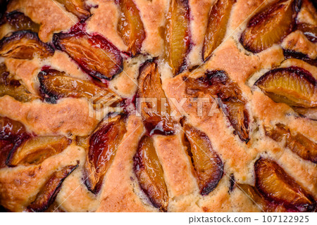 Delicious sweet aromatic homemade pie with ripe plums Delicious sweet aromatic homemade pie with ripe plums 107122925