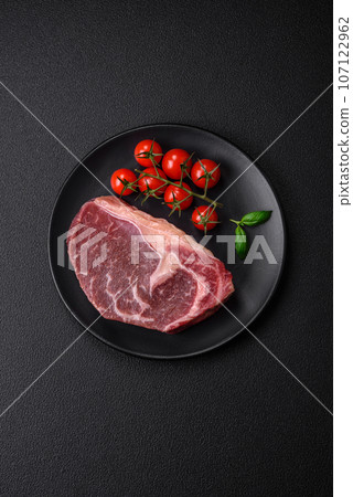 Fresh raw beef striploin steak with salt, spices and herbs Fresh raw beef striploin steak with salt, spices and herbs 107122962