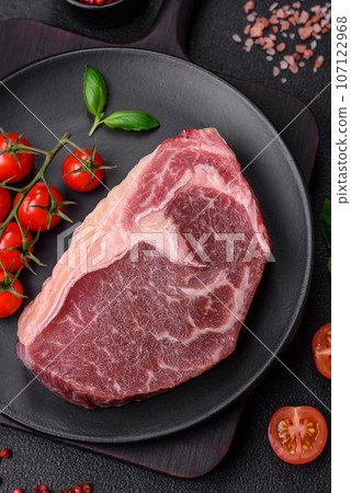 Fresh raw beef striploin steak with salt, spices and herbs Fresh raw beef striploin steak with salt, spices and herbs 107122968