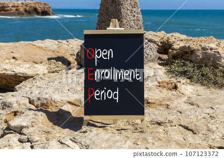 OEP symbol. Concept words OEP Open enrollment period on beautiful black chalk blackboard. Beautiful stone beach blue sea background. Medical and OEP Open enrollment period concept. Copy space. OEP symbol. Concept words OEP Open enrollment period on beautiful black chalk blackboard. Beautiful stone beach blue sea background. Medical and OEP Open enrollment period concept. Copy space. 107123372