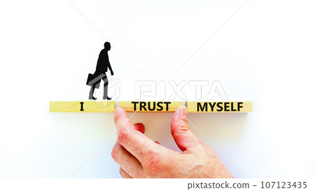 I trust myself symbol. Concept words I trust myself on wooden blocks. Businessman hand. Beautiful white table white background. Business, psychological and I trust myself concept. Copy space. I trust myself symbol. Concept words I trust myself on wooden blocks. Businessman hand. Beautiful white table white background. Business, psychological and I trust myself concept. Copy space. 107123435
