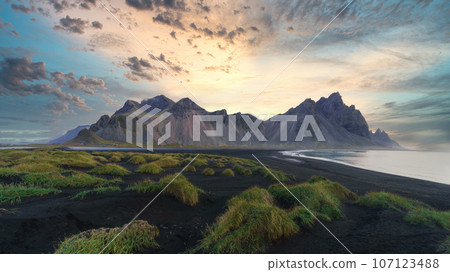 Stokksnes cape in Iceland during sunrise. Vestrahorn mountains. Amazing Iceland nature seascape. 107123488