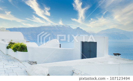 White architecture on Santorini island, Greece. Beautiful summer landscape. Blue sky and mountains. White architecture on Santorini island, Greece. Beautiful summer landscape. Blue sky and mountains. 107123494