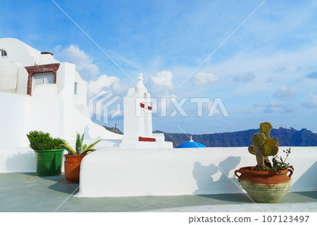 White architecture on Santorini island, Greece. Beautiful landscape with caldera sea view and cloudy sky. White architecture on Santorini island, Greece. Beautiful landscape with caldera sea view and cloudy sky. 107123497