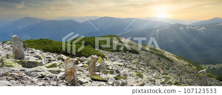 Sunset in green summer mountains. Vibrant photo wallpaper. The tranquil beauty of the earth concept. Sunset in green summer mountains. Vibrant photo wallpaper. The tranquil beauty of the earth concept. 107123533