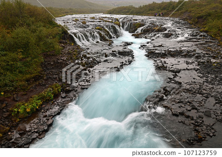 Visitors at Bruarfoss - Bridge Falls - on Iceland's Golden Circle route. Visitors at Bruarfoss - Bridge Falls - on Iceland's Golden Circle route. 107123759