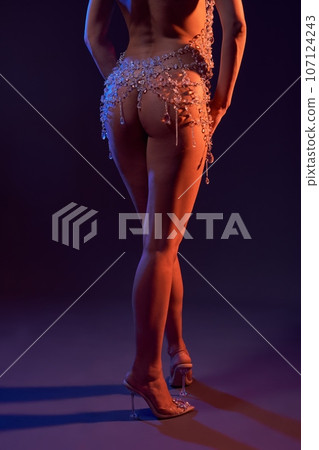 Bare buttocks of slim woman in crystal cloak Bare buttocks of slim woman in crystal cloak 107124243
