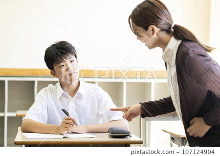 Students and teacher teaching in a school classroom 107124904