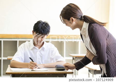 Students and teacher teaching in a school classroom Students and teacher teaching in a school classroom 107124909