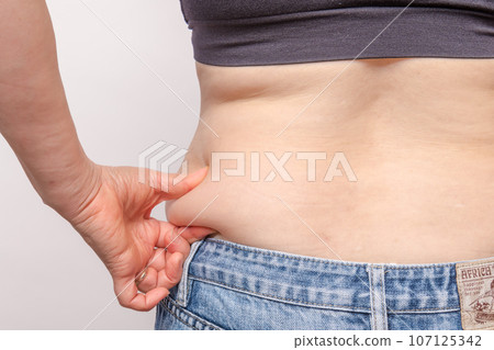 [Back view of a housewife picking meat from her side] 107125342