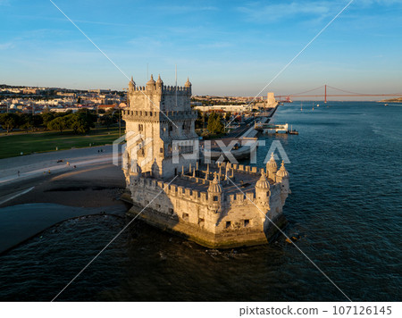 Aerial view of Belem Tower famous tourist landmark of Lisboa and tourism attraction on the bank of the Tagus River (Tejo) with tourist boats at sunset. Lisbon, Portugal Aerial view of Belem Tower famous tourist landmark of Lisboa and tourism attraction on the bank of the Tagus River (Tejo) with tourist boats at sunset. Lisbon, Portugal 107126145