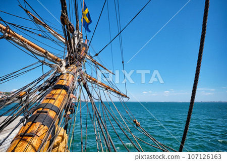 Bowspirit of old wooden sail ship with a lot of gear cordage rope 107126163