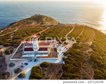 Aerial drone view of lighthouse on Cabo Espichel cape Espichel on Atlantic ocean at sunset. Sesimbra, Portugal Aerial drone view of lighthouse on Cabo Espichel cape Espichel on Atlantic ocean at sunset. Sesimbra, Portugal 107126200