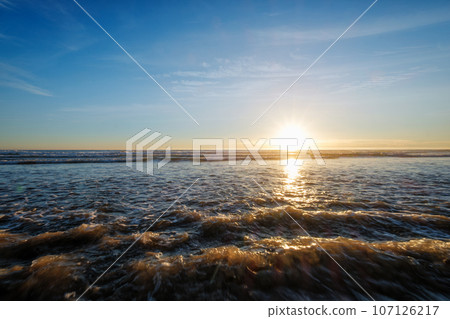 Atlantic ocean sunset with surging waves at Fonte da Telha beach, Costa da Caparica, Portugal Atlantic ocean sunset with surging waves at Fonte da Telha beach, Costa da Caparica, Portugal 107126217