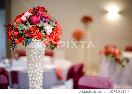 Festive bouquets of red roses in vases Festive bouquets of red roses in vases 107131134