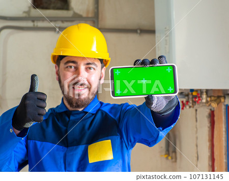 Portrait of worker or engineer in blue work clothes and yellow safety helmet Portrait of worker or engineer in blue work clothes and yellow safety helmet 107131145