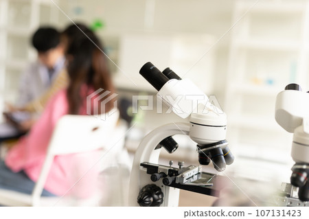 STEM education concept. Asian children in laboratory research an experiment exam with microscope. The new education system in a classroom including Science, Technology, Engineering and Mathematics. 107131423