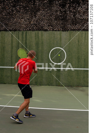 man playing tennis man playing tennis 107137108