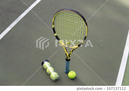 close-up. male hands holding tennis racket and balls close-up. male hands holding tennis racket and balls 107137112