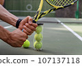 close-up. male hands holding tennis racket and balls 107137118