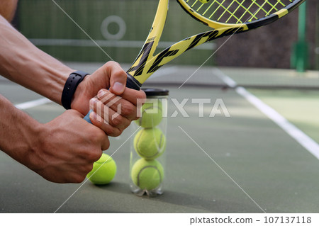 close-up. male hands holding tennis racket and balls 107137118