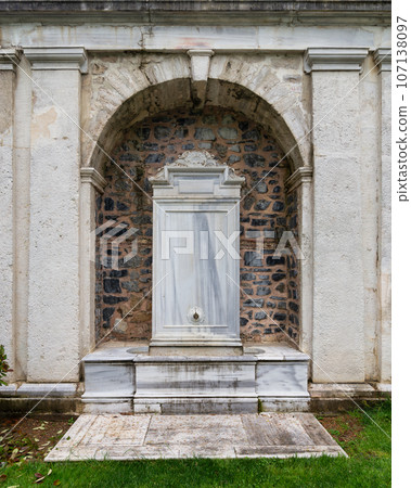 Marble fountain surrounded by a stone wall located in the garden of the Mecidiye Pavilion, Istanbul, Turkey 107138097