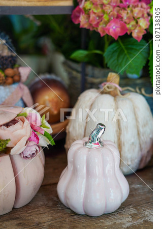 Decorative autumn pink artificial pumpkins and flowers in the store. Autumn, fall, harvest, Thanksgiving Decorative autumn pink artificial pumpkins and flowers in the store. Autumn, fall, harvest, Thanksgiving 107138305