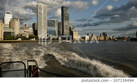 A sightseeing boat goes near the Tower Bridge. London A sightseeing boat goes near the Tower Bridge. London 107138494